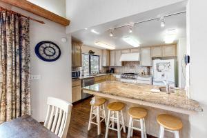 a kitchen with a counter and a clock on the wall at Forest Falls in Shaver Lake