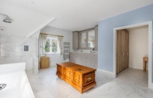a bathroom with a wooden table in a room at Luccombe Chine House - Rare Find - Spectacular Secluded Coastal Manor, Breathtaking Ocean Views short drive to Shanklin or Ventnor Beach - near Shanklin Old Village in Shanklin