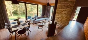 a living room with a couch and a table and chairs at Chalet Slovensky Raj in Smižany