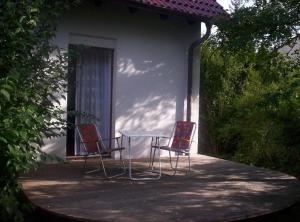 two chairs and a table in front of a house at Ferien-und-Messeappartement-Falke in Fürth