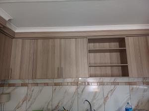 a kitchen with wooden cabinets and a white ceiling at Sheeroh's Place in Burgersfort +11 photos