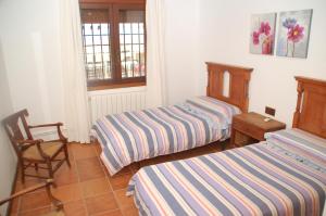 Łóżko lub łóżka w pokoju w obiekcie Casa rural Dalia
