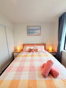 a bedroom with a large bed with two towels on it at Tranquil 3 Bed Minutes To CBD And Arena, Sleeps 7 in Christchurch