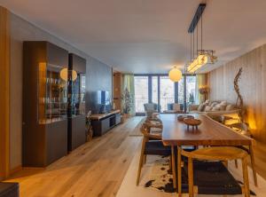 a living room with a wooden table and a dining room at Isard Homes by Select Rentals in El Tarter