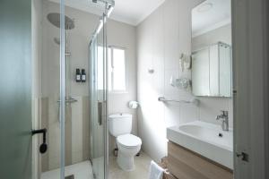 a bathroom with a toilet and a sink and a shower at La Posada Hospedería in Vejer de la Frontera