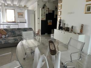 a living room with a glass table and chairs at Stellina in Mozzecane