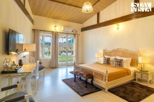 Ένα ή περισσότερα κρεβάτια σε δωμάτιο στο StayVista at Ekaa House with BBQ, Bonfire, WiFi, Lawn & Pet Friendly