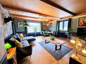 a living room with a couch and a table at Alp Haus Grossglockner in Bruck an der Großglocknerstraße