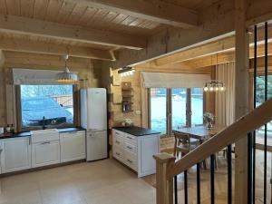 a kitchen with a refrigerator and a dining table at Ski&Chill Rafaczówki in Poronin