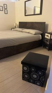 a bedroom with a bed with a table and a mirror at Casa Lido in Lido di Ostia