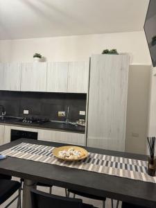 a kitchen with a table with a plate on it at Casa Lido in Lido di Ostia