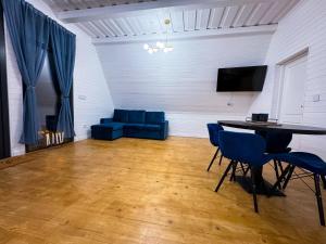 a living room with a table and a blue couch at A Frame Girasole in Colibiţa