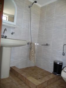 a bathroom with a shower and a sink and a toilet at Zourpos Studios & Apartments in Kalyves