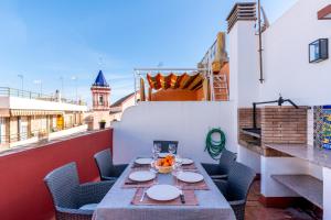 a table on the balcony of a building at Holi-Rent Penthouse Peñuelas in Seville