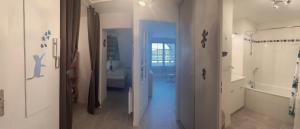 a hallway with a bathroom with a toilet and a sink at Cap des pins in Quend