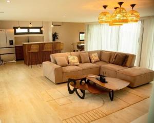 a living room with a couch and a table at Villa paradisiaque à Assinie 10 personnes in Assinie
