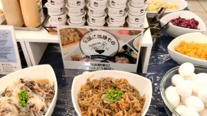 a table topped with bowls of food and eggs at Toyoko Inn Akita-eki Higashi-guchi in Akita