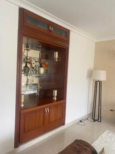 a large wooden cabinet in the corner of a room at Residence La Marina in Yaoundé