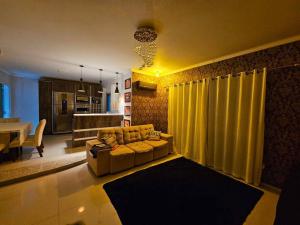 soggiorno con divano e tenda gialla di Duda House com piscina aquecida a Penha Altre 36 foto