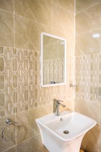 a bathroom with a sink and a mirror at Jebel Shams Hills in Misfāh +44 photos