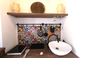 a bathroom with a sink and a mirror at La casetta del cortile in Siracusa