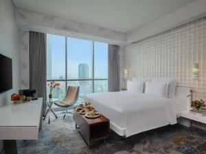 Voodi või voodid majutusasutuse Pullman Jakarta Central Park toas