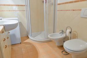 a bathroom with a shower and a toilet and a sink at Casa Miramonti in Ossana