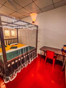 a bedroom with a bed and a table with a red floor at White House Mirissa in Mirissa +27 photos