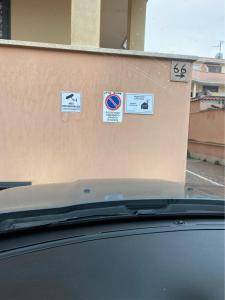 a car parked in front of a wall with signs on it at Little House in Fiumicino +10 photos