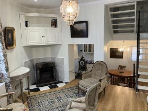 a living room with a fireplace and a table and chairs at La Maison des Sources in Brussels