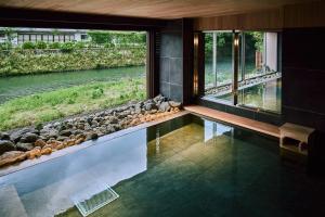 a room with a large window with a view of a river at Ryokan Oomuraya in Ureshino
