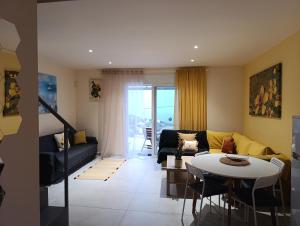 a living room with a couch and a table at Altheas Maisonettes in Xylokastro