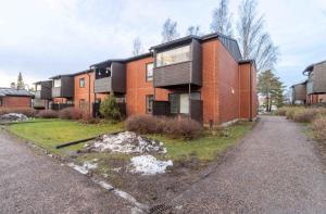 an apartment building with a red brick at Good 3 rooms apartment with free parking & beds for 6! in Helsinki