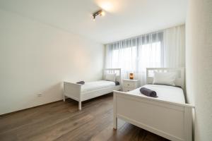 Postel nebo postele na pokoji v ubytování Swiss Suites - Menziken