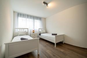 Postel nebo postele na pokoji v ubytování Swiss Suites - Menziken
