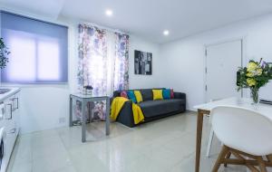a living room with a couch and a table at El Balneario in Cádiz