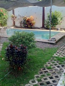 a backyard with a swimming pool and a house at Lucky777 Homestay in Mambajao