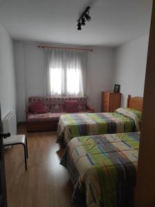a room with two beds and a couch in it at El Balcón de la Sierra in Mora de Rubielos