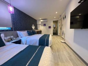 Uma cama ou camas num quarto em 墾丁卿卿文旅