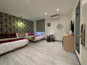 Uma cama ou camas num quarto em 墾丁卿卿文旅