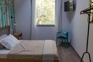 a bedroom with a bed and a chair and a window at Saranto, Maison du charme - Nel cuore verde dell'Emilia in Carpi +24 photos
