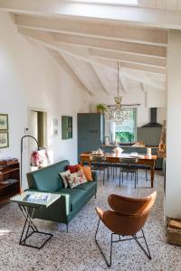 a living room with a couch and a table at Saranto, Maison du charme - Nel cuore verde dell'Emilia in Carpi