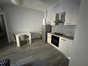 una cocina con una mesa y una estufa horno superior en Domus KA 1, en Cremona
