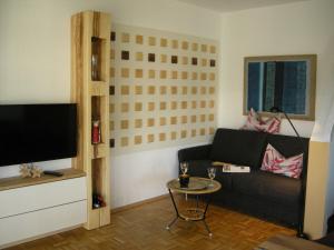 a living room with a couch and a table at Hideaway - Ibbenbüren in Ibbenbüren