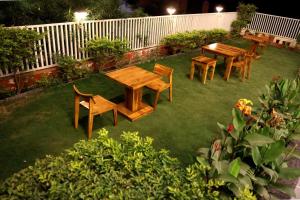 a group of tables and chairs in a yard at Platinum Royal Excellency in Udaipur