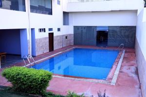 a swimming pool in front of a building at Platinum Royal Excellency in Udaipur