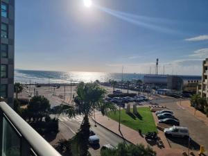 a view of a parking lot next to the ocean at חדר שינה וסלון ומרפסת נוף לים in Herzliyya B +5 photos