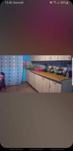 a kitchen with white cabinets and a counter top at guest house welcome in Khulo