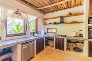 a kitchen with wooden cabinets and a counter top at Casa Laila Cozy House in Bacalar Center in Bacalar +40 photos
