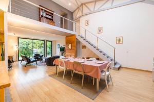a dining room with a table and a staircase at Magnifique maison a Pleubian proche de la mer in Pleubian